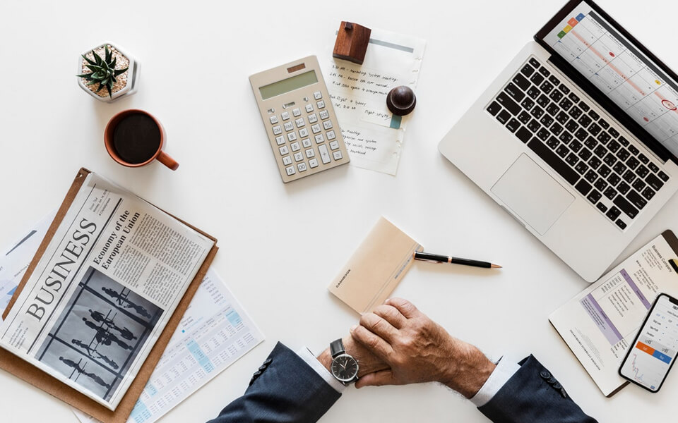 picture containing a laptop, coffe, a newspaper
